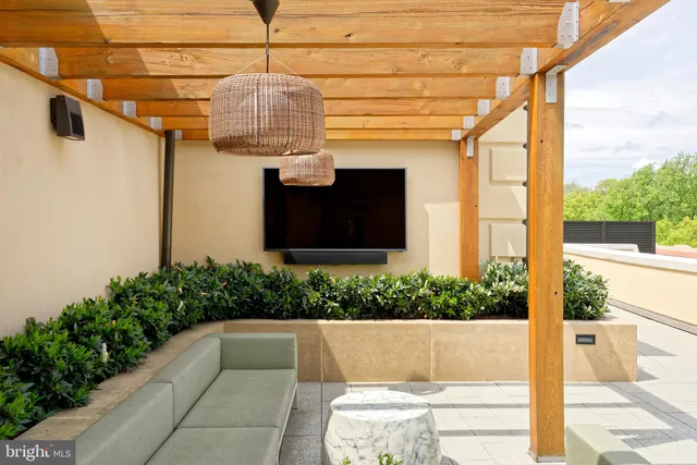a view of a patio with couches table and chairs and potted plants
