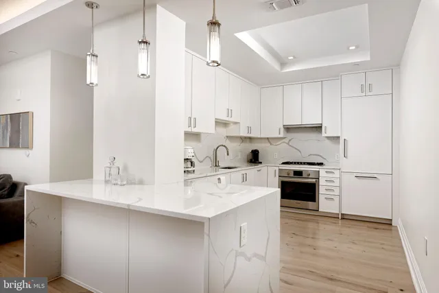 a kitchen with stainless steel appliances granite countertop a sink stove and refrigerator