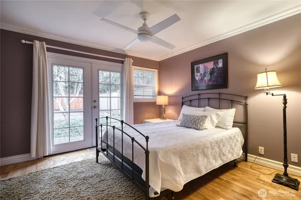 a bedroom with a bed and a large window