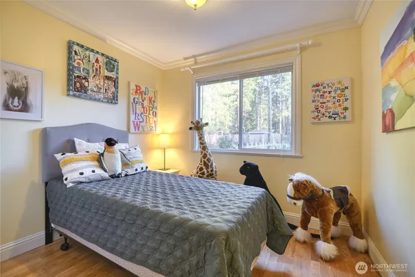 a bed sitting in a bedroom next to a window