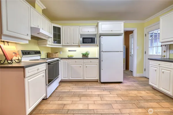 a kitchen with stainless steel appliances granite countertop a refrigerator sink and cabinets