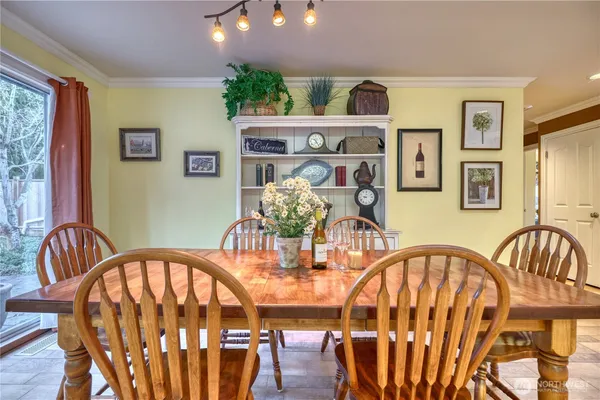 a view of a dining room with furniture and chandelier