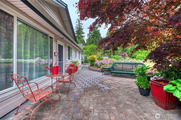 a view of a chairs and table in backyard of the house