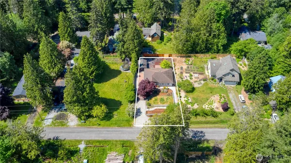 an aerial view of residential house with outdoor space and swimming pool