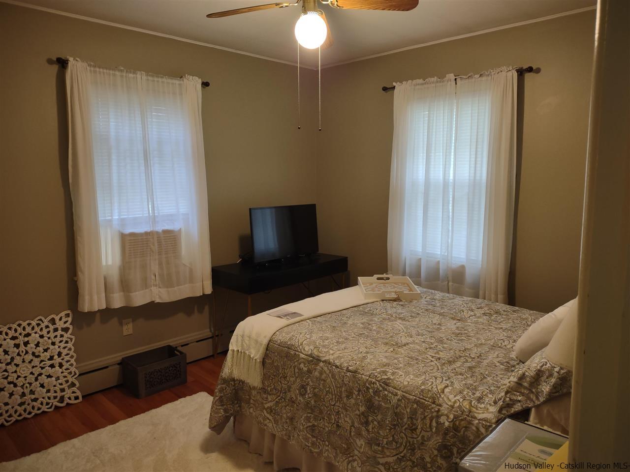 685 Churchland Road Saugerties, NY 12477 - Photo 5 of 30 a bedroom with a bed and a chandelier