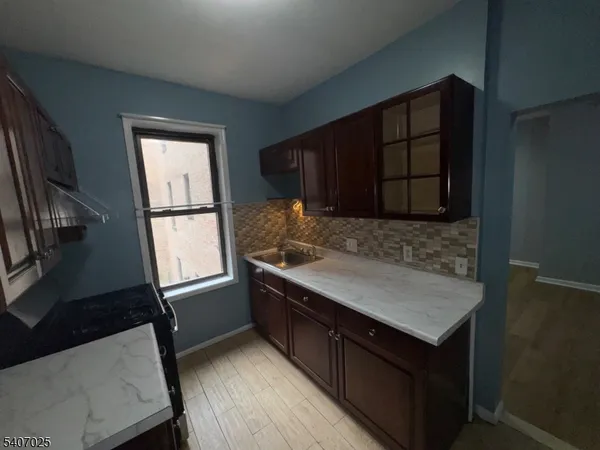 a kitchen with wooden cabinets and a sink