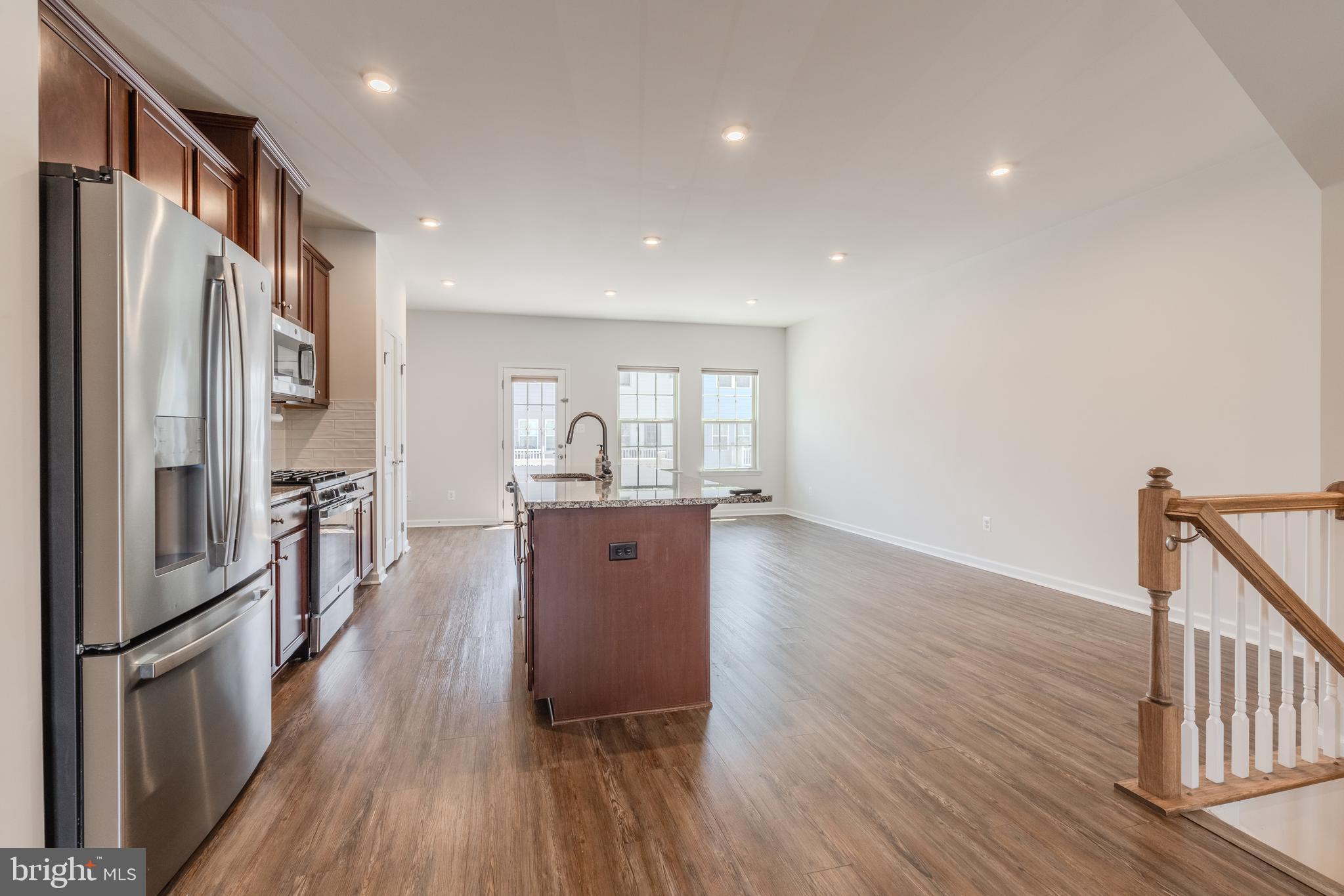 18191 Red Mulberry Road Dumfries, VA 22026 - Photo 11 of 42 a kitchen with stainless steel appliances a refrigerator and wooden floor