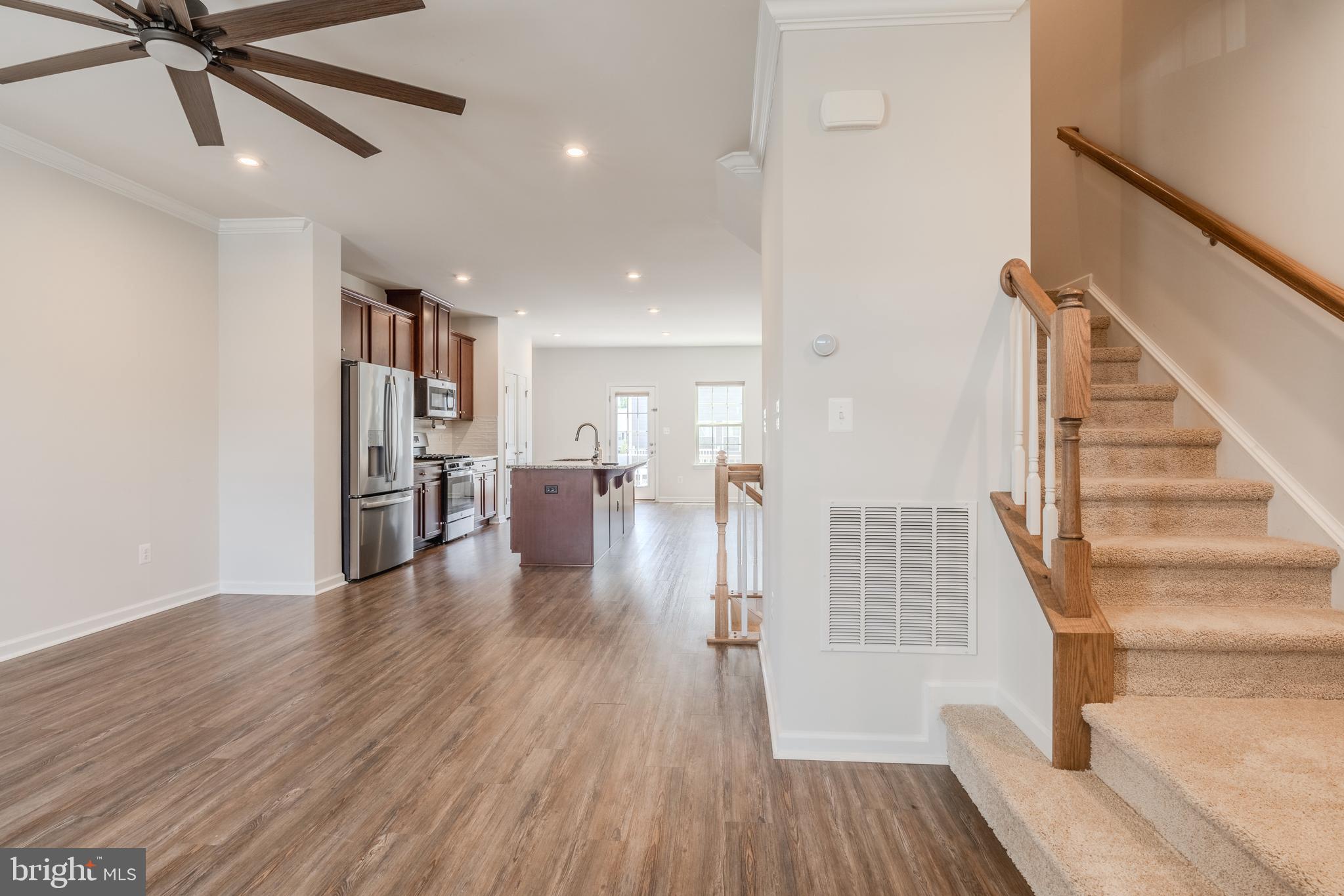 18191 Red Mulberry Road Dumfries, VA 22026 - Photo 12 of 42 a view of a livingroom with wooden floor and staircase