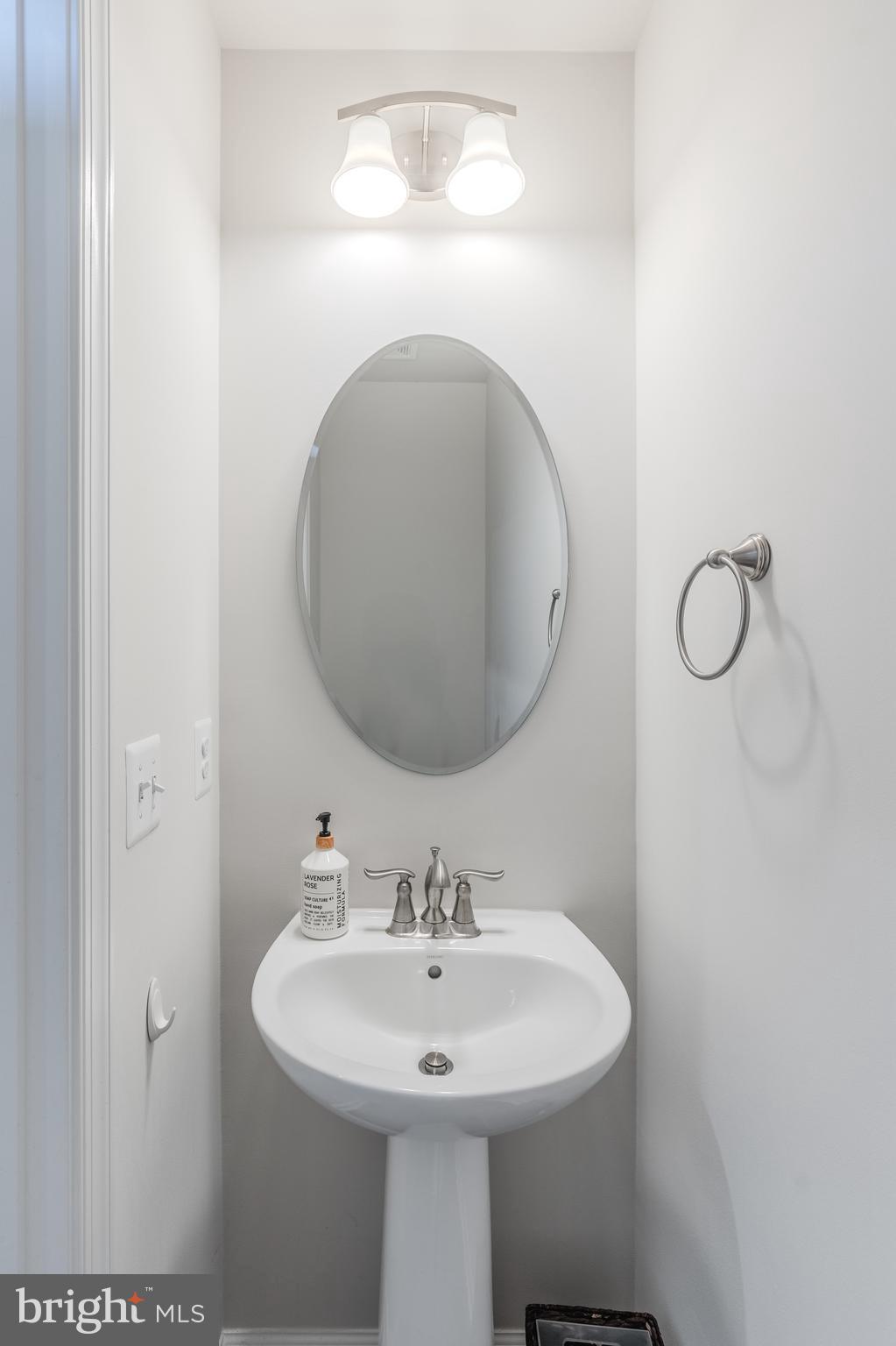 18191 Red Mulberry Road Dumfries, VA 22026 - Photo 13 of 42 a bathroom with a sink and a mirror