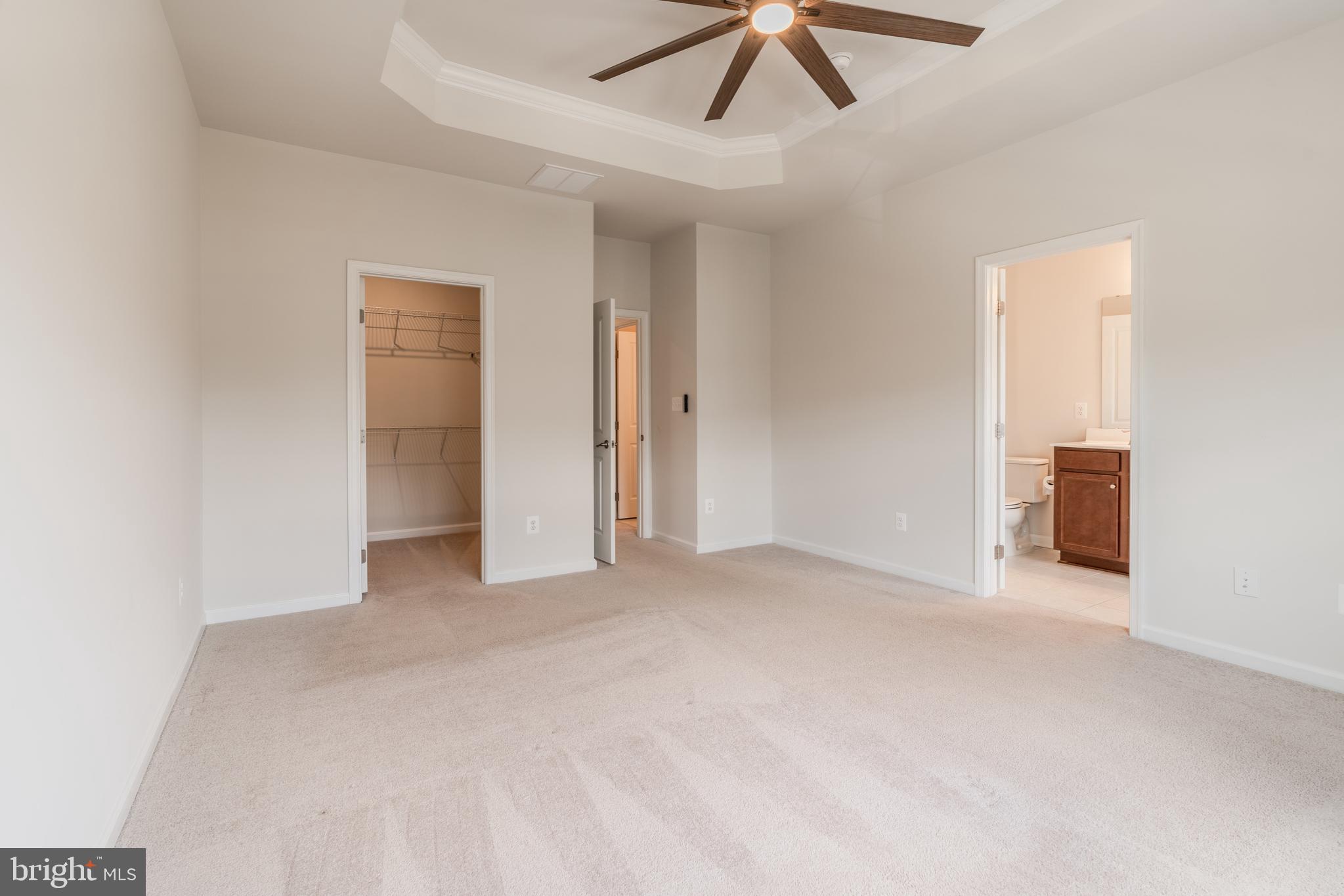 18191 Red Mulberry Road Dumfries, VA 22026 - Photo 20 of 42 an empty room with chandelier fan and windows