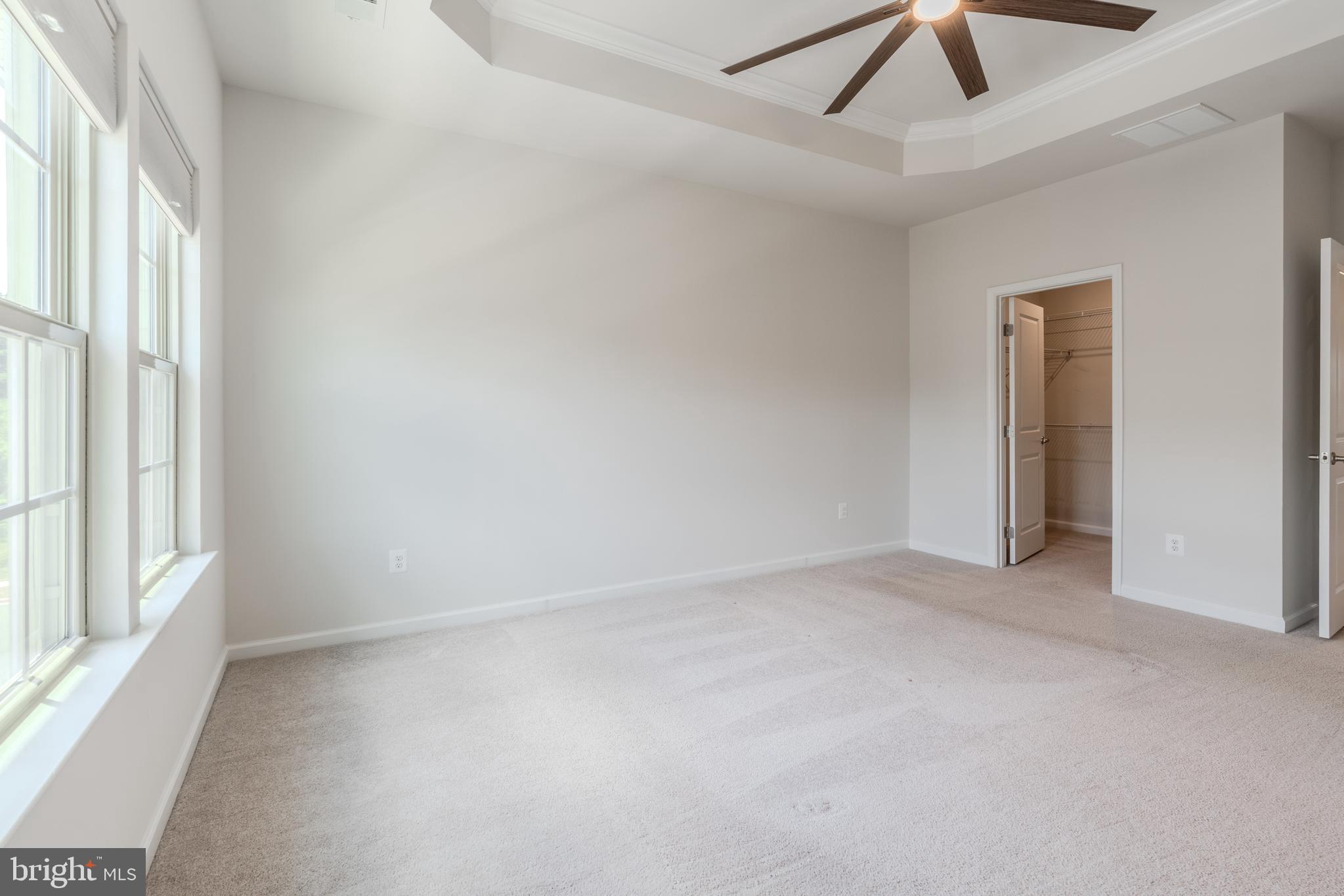 18191 Red Mulberry Road Dumfries, VA 22026 - Photo 21 of 42 an empty room with a ceiling fan and windows