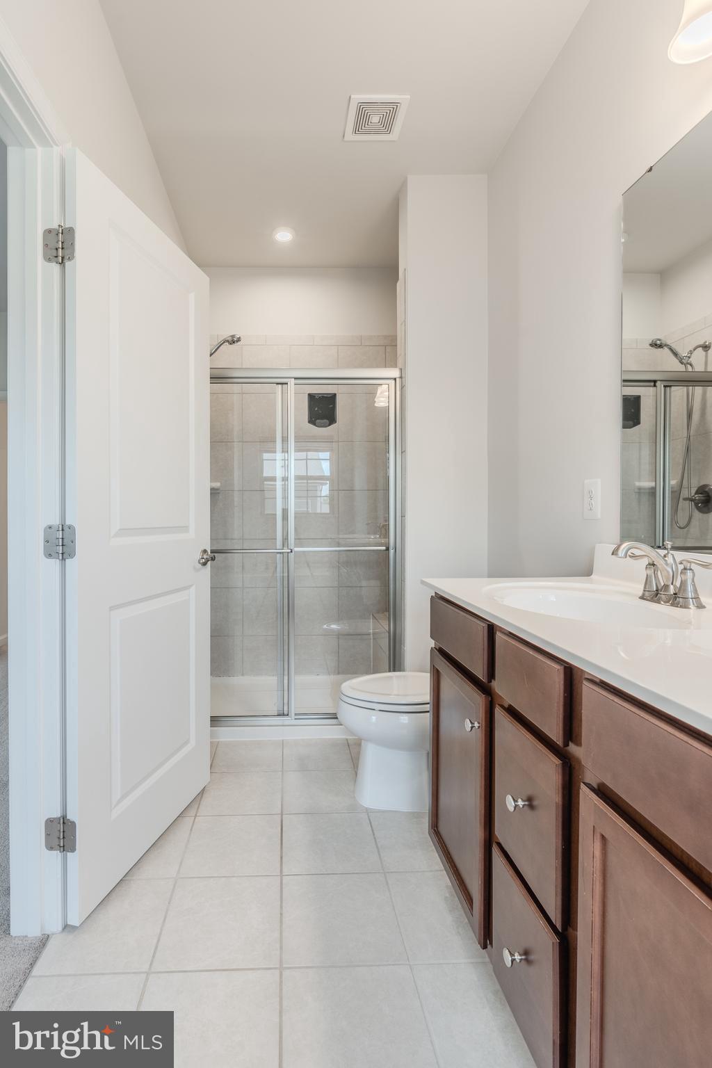 18191 Red Mulberry Road Dumfries, VA 22026 - Photo 24 of 42 a bathroom with a sink a toilet and shower
