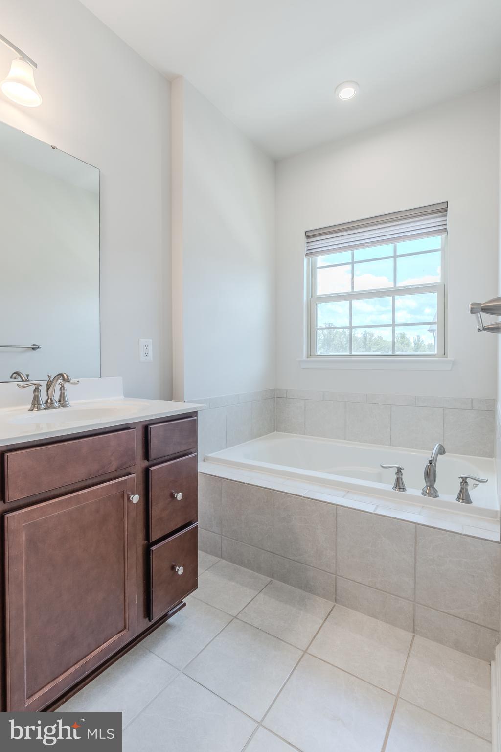 18191 Red Mulberry Road Dumfries, VA 22026 - Photo 26 of 42 a bathroom with a tub sink and mirror