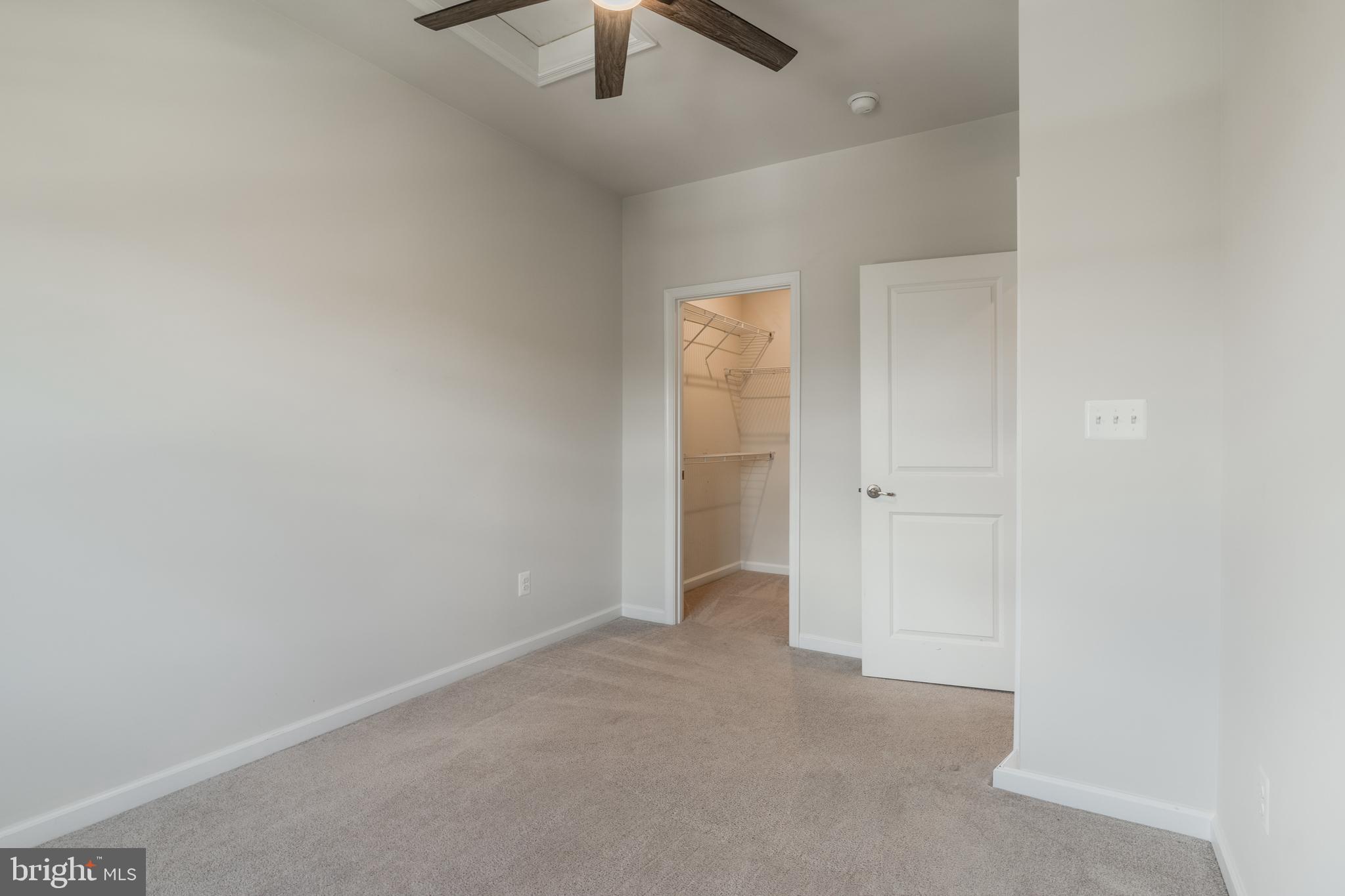 18191 Red Mulberry Road Dumfries, VA 22026 - Photo 32 of 42 an empty room with chandelier fan