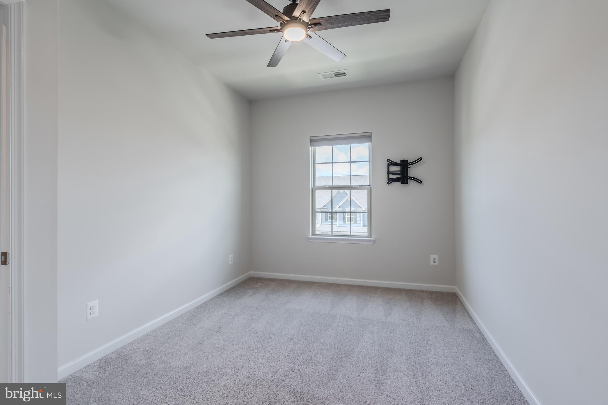 18191 Red Mulberry Road Dumfries, VA 22026 - Photo 35 of 42 an empty room with a window and a ceiling fan