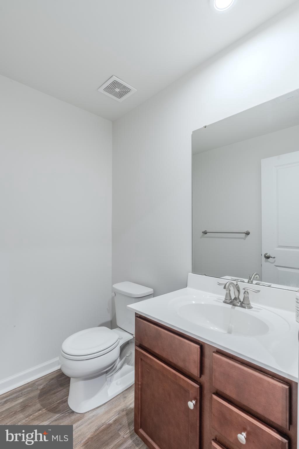 18191 Red Mulberry Road Dumfries, VA 22026 - Photo 39 of 42 a bathroom with a sink a toilet and a mirror