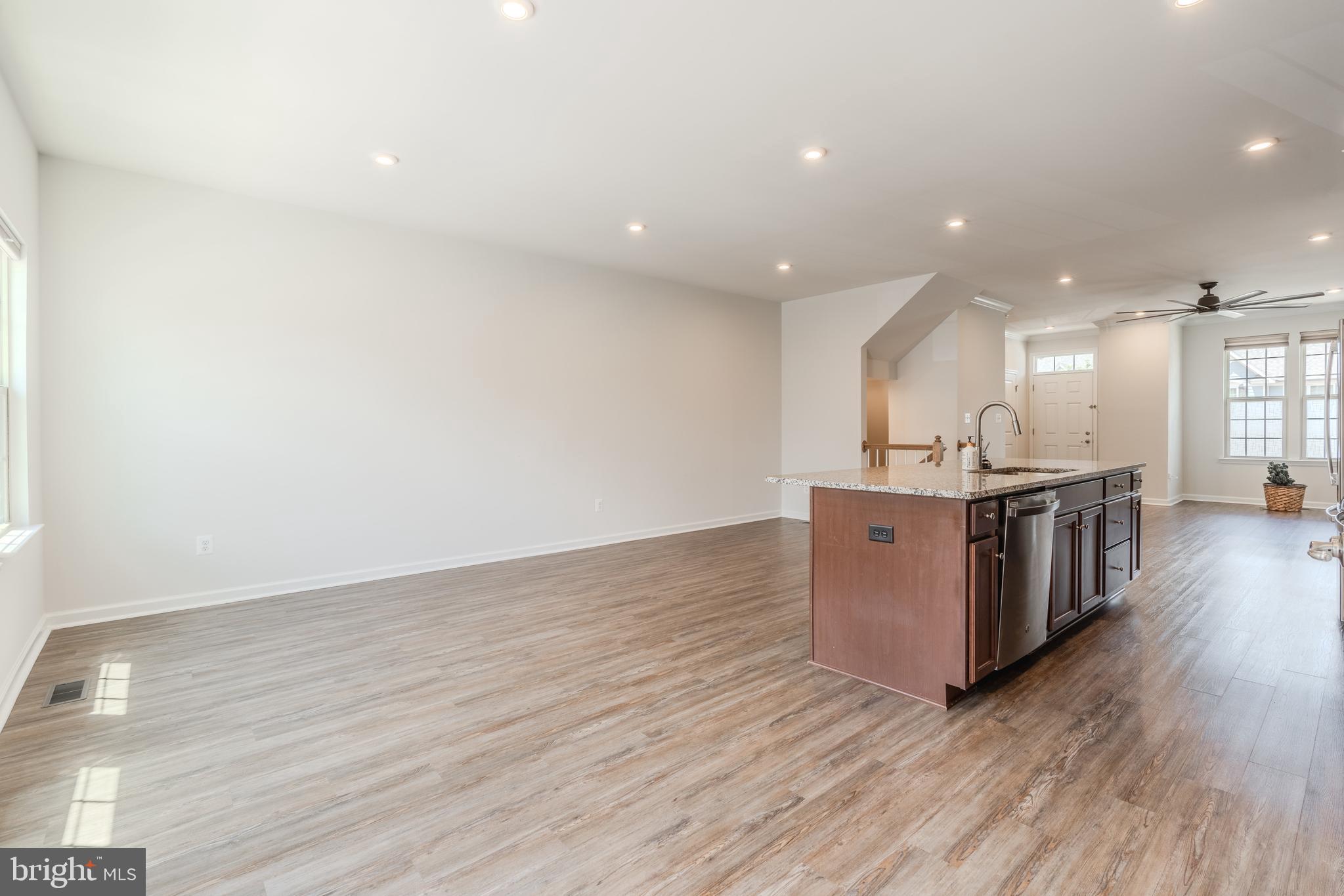 18191 Red Mulberry Road Dumfries, VA 22026 - Photo 10 of 42 a view of kitchen with kitchen island wooden floors and stainless steel appliances