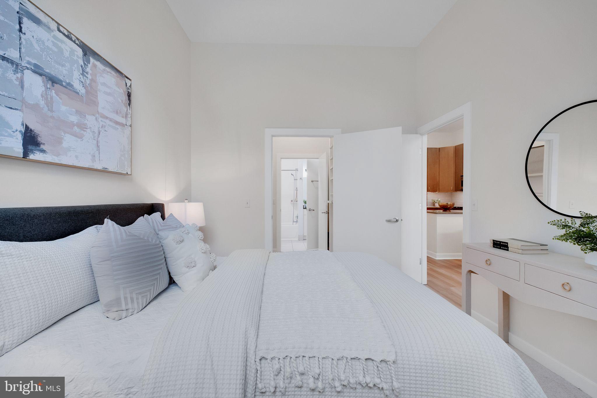 1000 New Jersey Avenue Southeast, Unit 103 Washington, DC 20003 - Photo 11 of 21 a large white bed in a white room