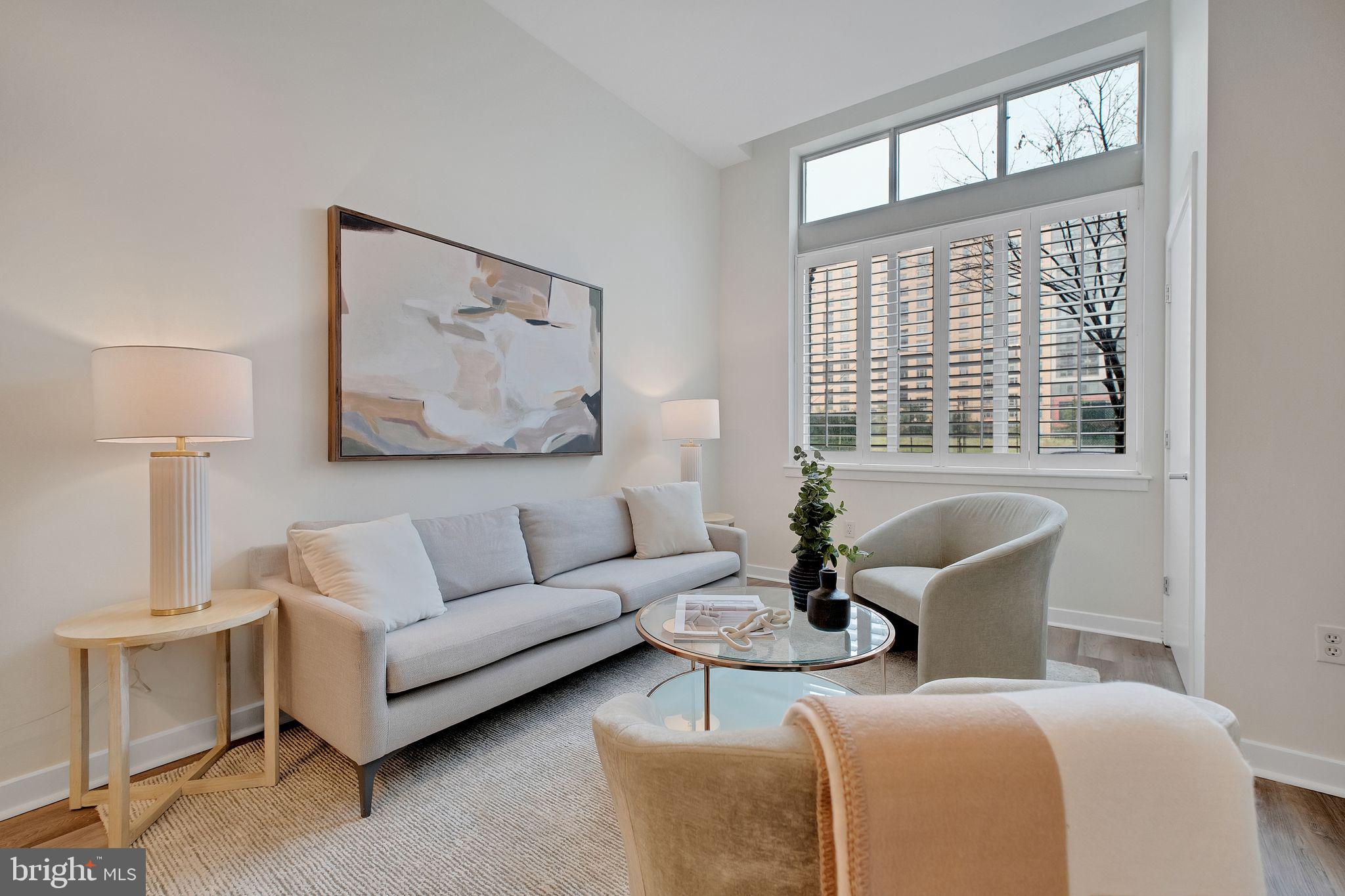 1000 New Jersey Avenue Southeast, Unit 103 Washington, DC 20003 - Photo 6 of 21 a living room with furniture and a large window