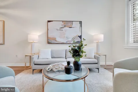 a living room with furniture and a lamp