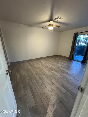wooden floor in an empty room with a chandelier