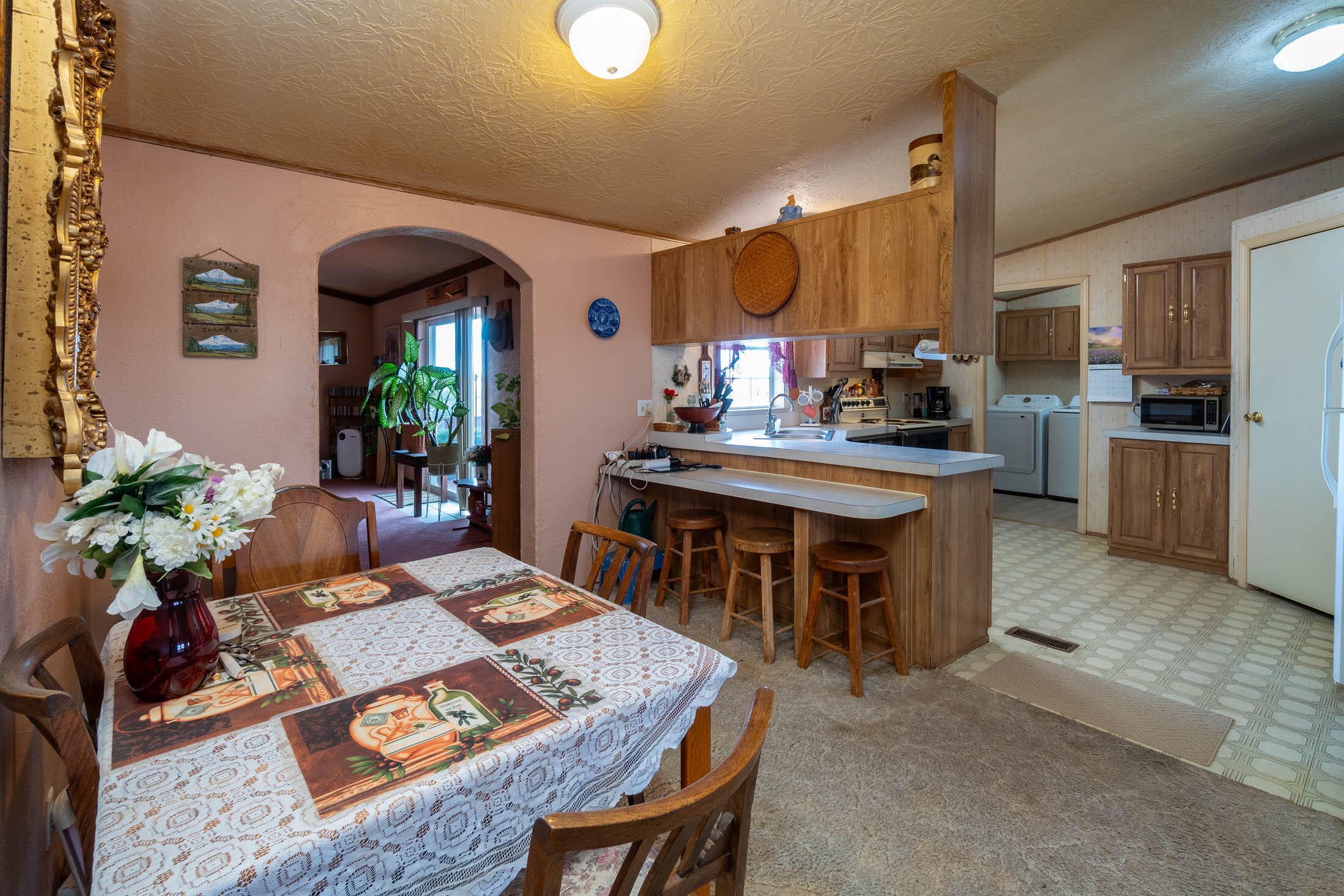 25907 South Cooper Street Bend, OR 97701 - Photo 11 of 34 a living room with stainless steel appliances kitchen island granite countertop furniture and a kitchen view