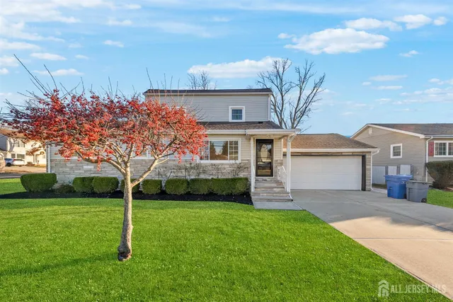a front view of house with yard and green space