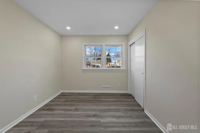 a view of a room with wooden floor and cabinet