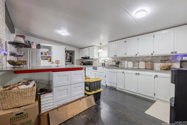 a kitchen with cabinets a sink and appliances