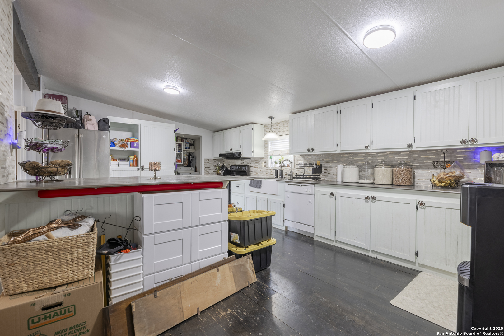 323 County Road 6842 Lytle, TX 78052 - Photo 11 of 25 a kitchen with cabinets a sink and appliances