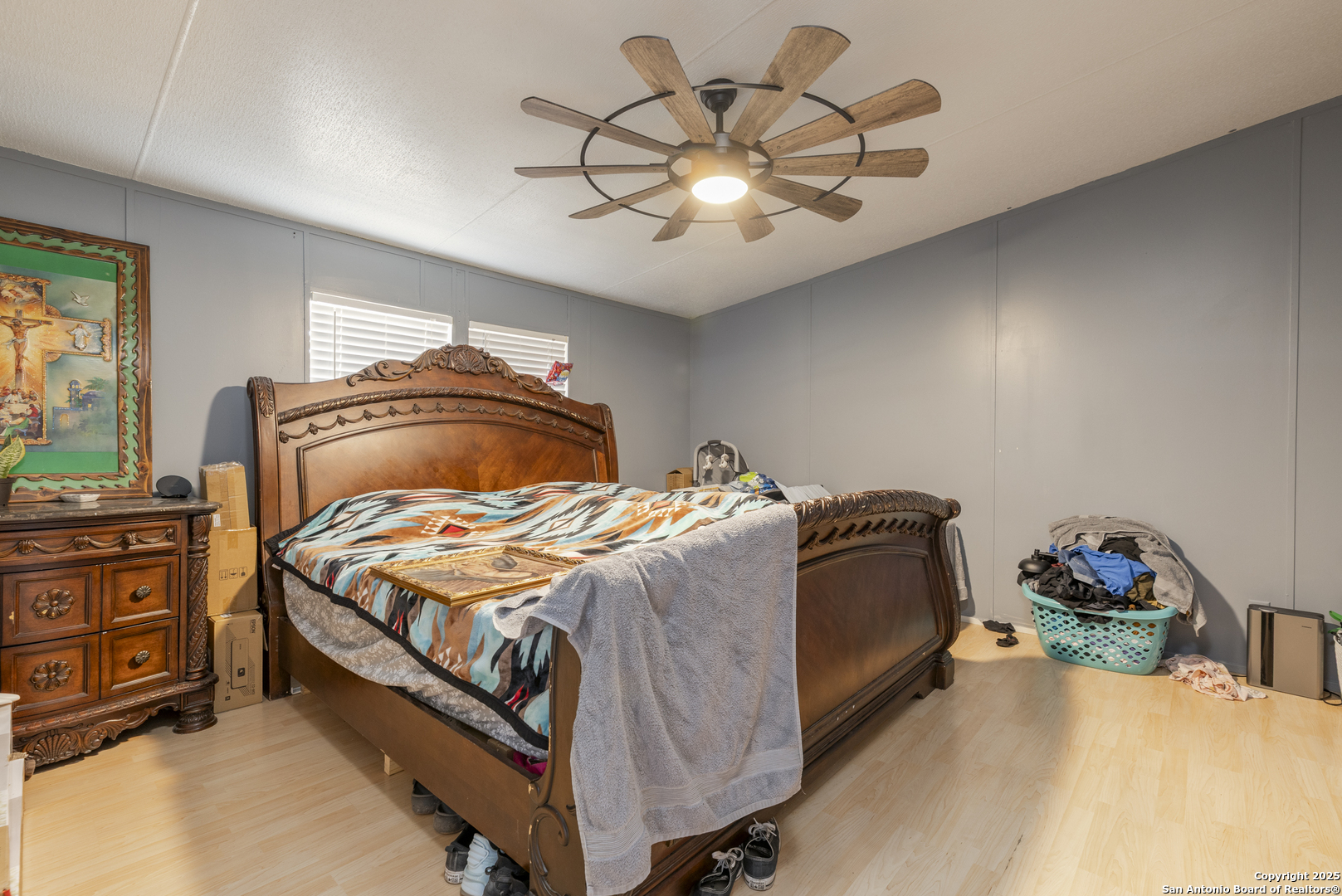 323 County Road 6842 Lytle, TX 78052 - Photo 12 of 25 a bedroom with a bed and a chandelier
