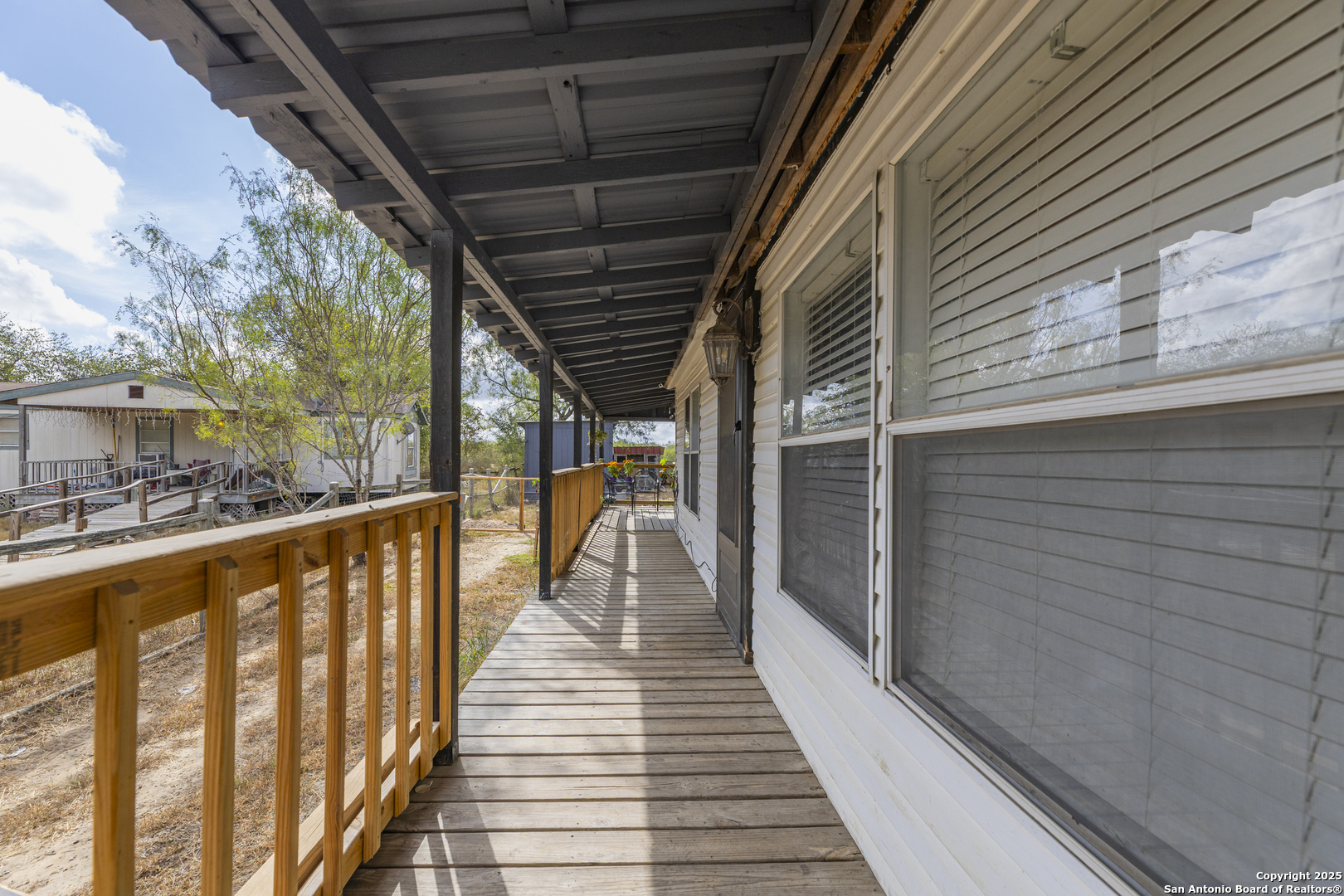 323 County Road 6842 Lytle, TX 78052 - Photo 2 of 25 a view of balcony with wooden floor