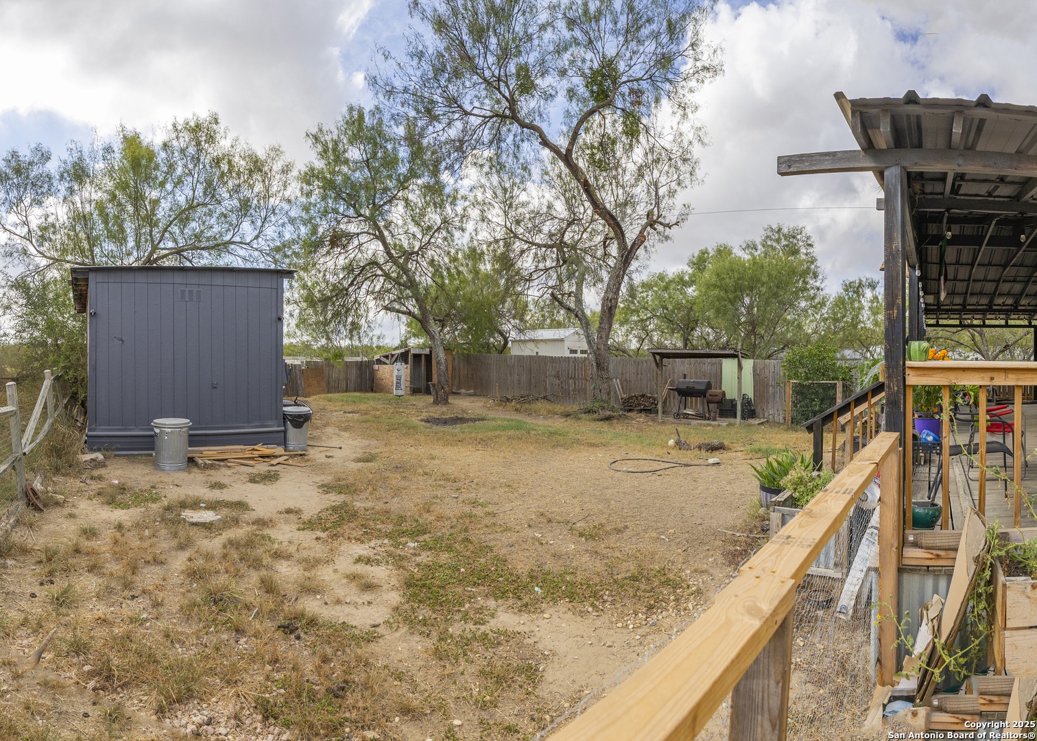 323 County Road 6842 Lytle, TX 78052 - Photo 21 of 25 a view of house with backyard and trees