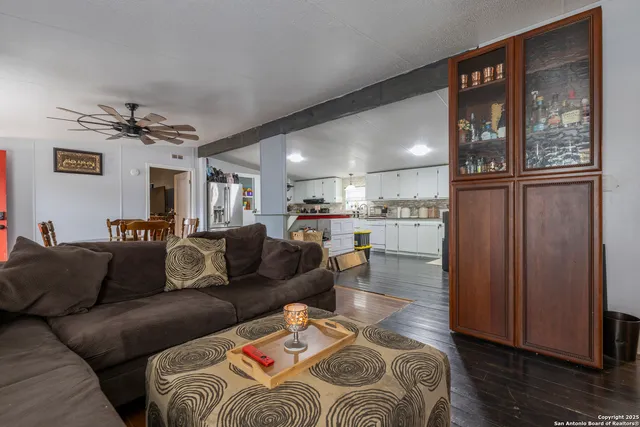 a living room with a couch and a view of kitchen