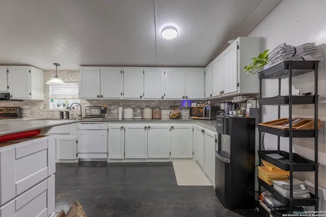 a kitchen with cabinets and window