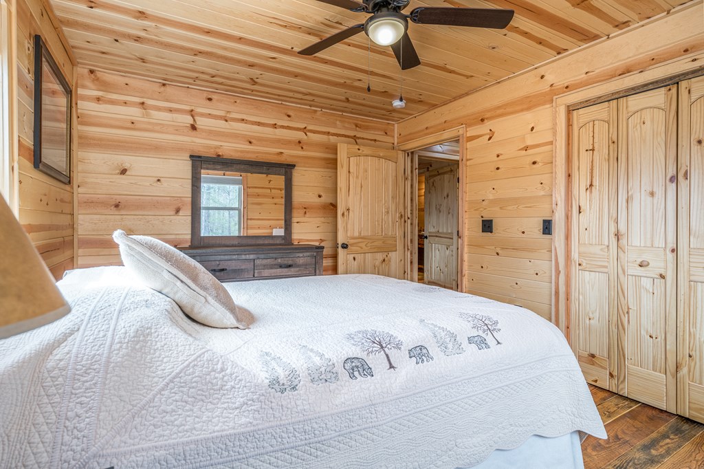 110 Sawtooth Rdg Road Murphy, NC 28906 - Photo 23 of 37 a spacious bedroom with a bed and a chandelier