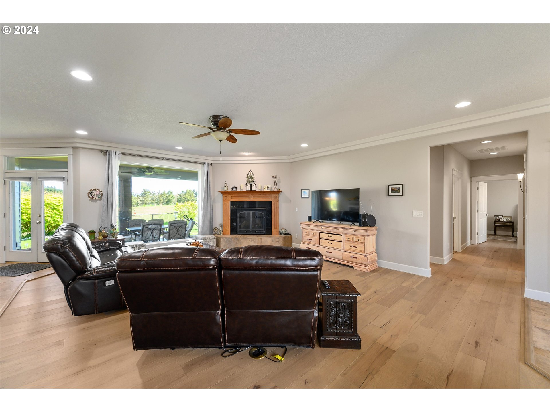 4216 Northwest 289th Street Ridgefield, WA 98642 - Photo 11 of 40 a living room with furniture a flat screen tv and a fireplace