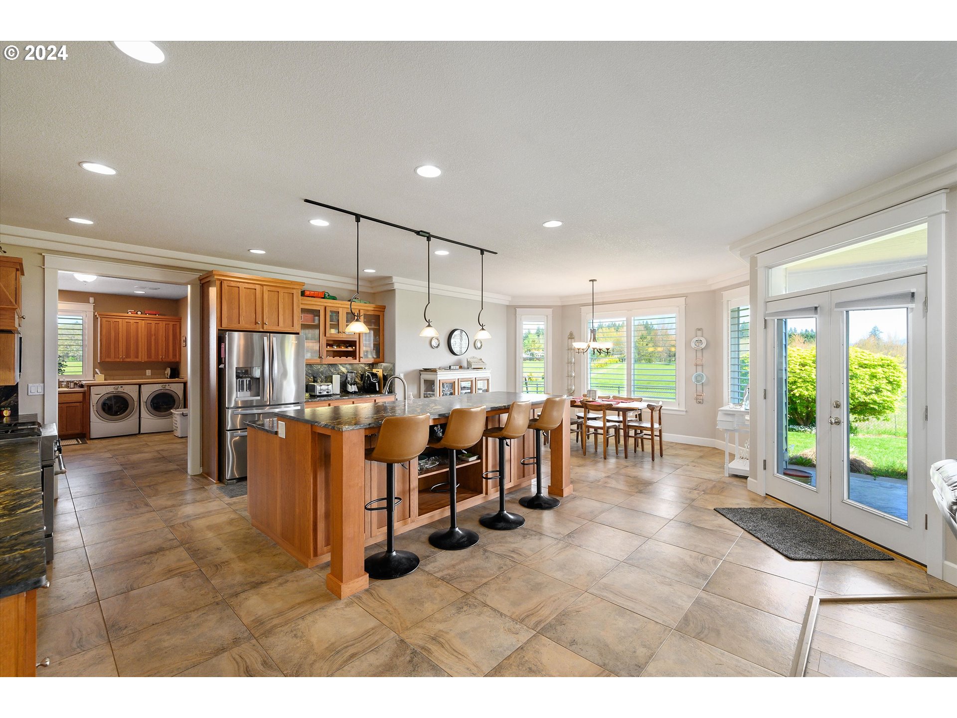 4216 Northwest 289th Street Ridgefield, WA 98642 - Photo 13 of 40 a room with lots of tables a large window and chairs