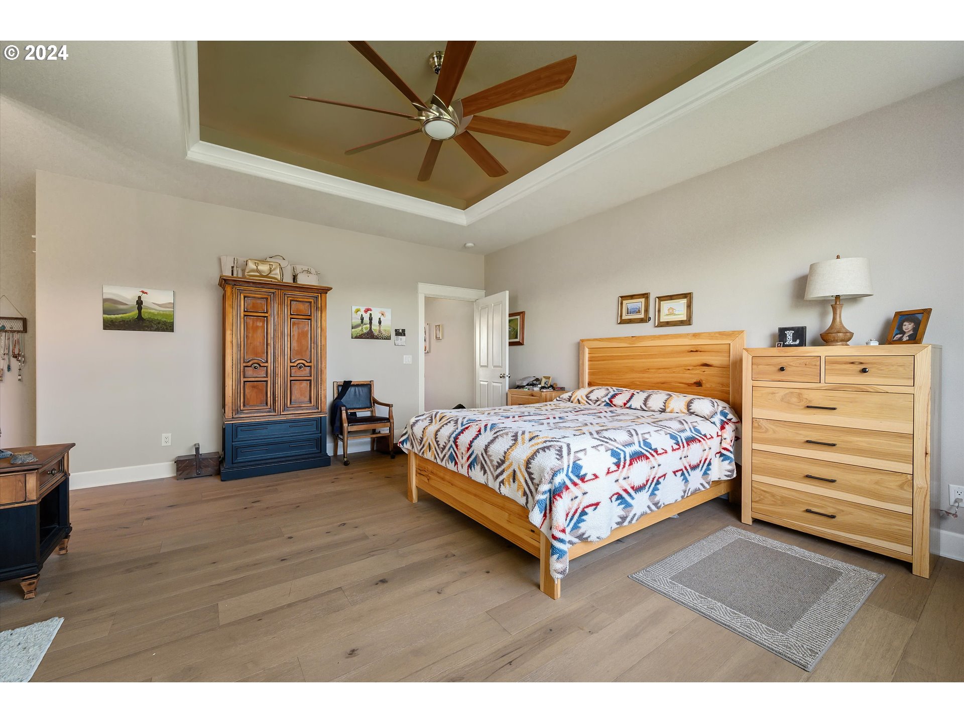 4216 Northwest 289th Street Ridgefield, WA 98642 - Photo 23 of 40 a bedroom with a bed and a chandelier