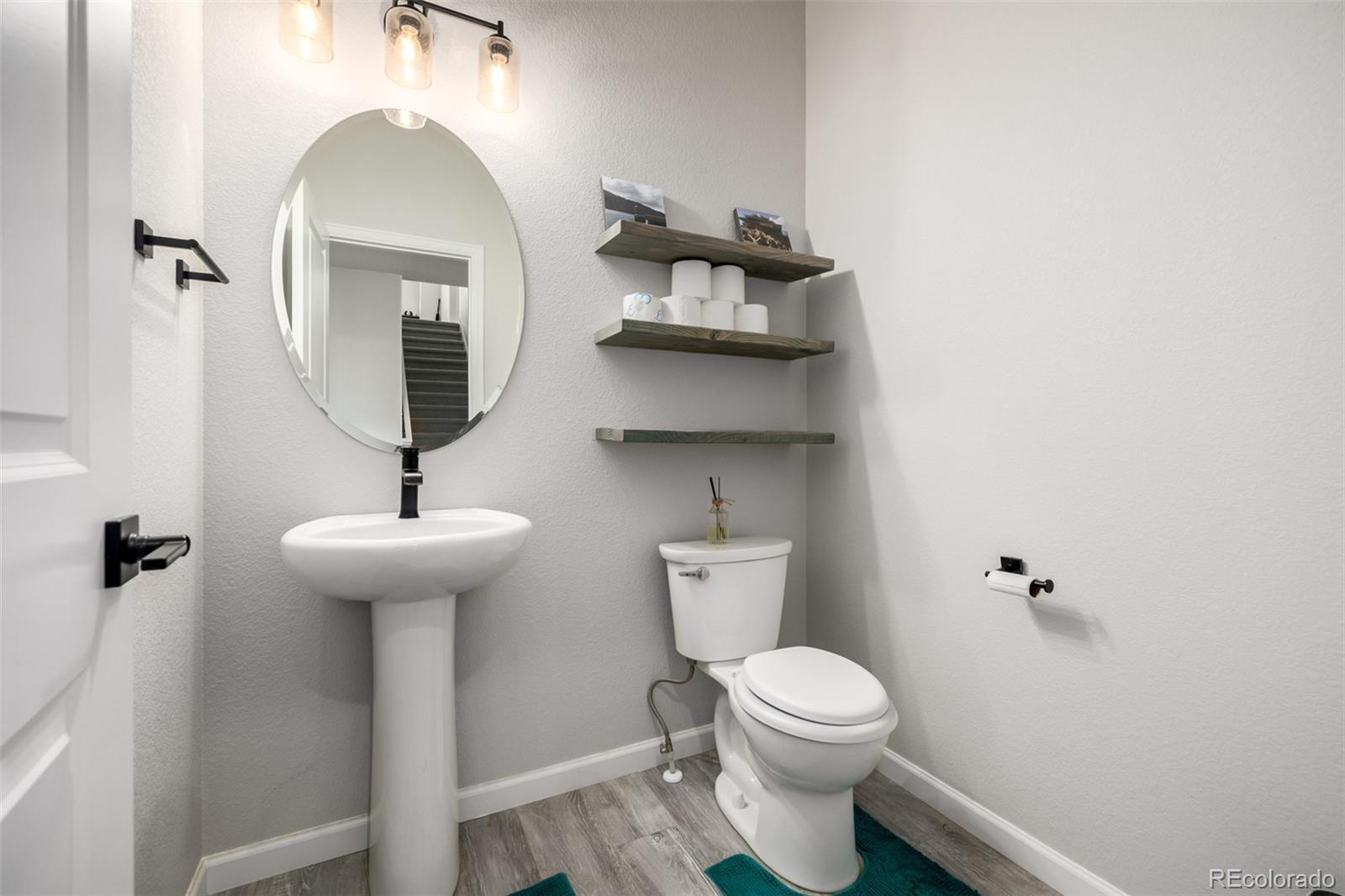 1875 Rancher Drive Milliken, CO 80543 - Photo 12 of 50 a bathroom with a toilet sink and mirror