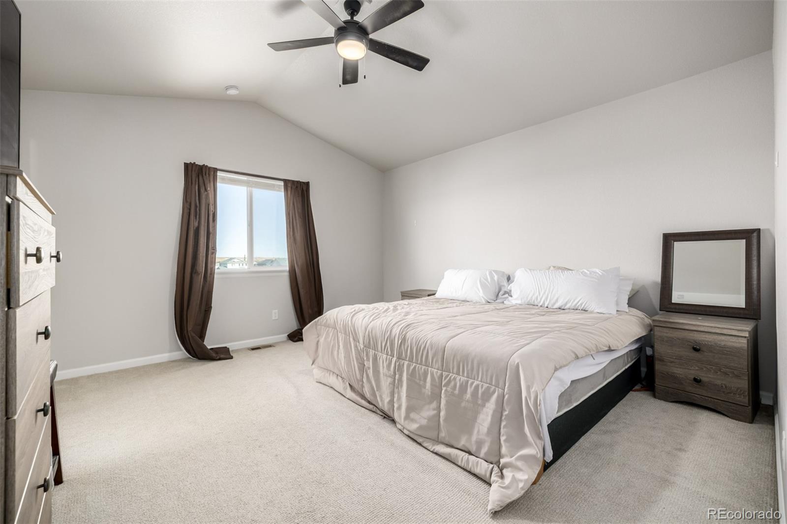 1875 Rancher Drive Milliken, CO 80543 - Photo 13 of 50 a bedroom with a bed and a window