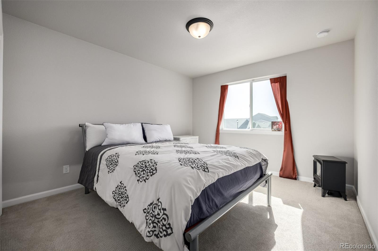 1875 Rancher Drive Milliken, CO 80543 - Photo 21 of 50 a bedroom with a bed and a window