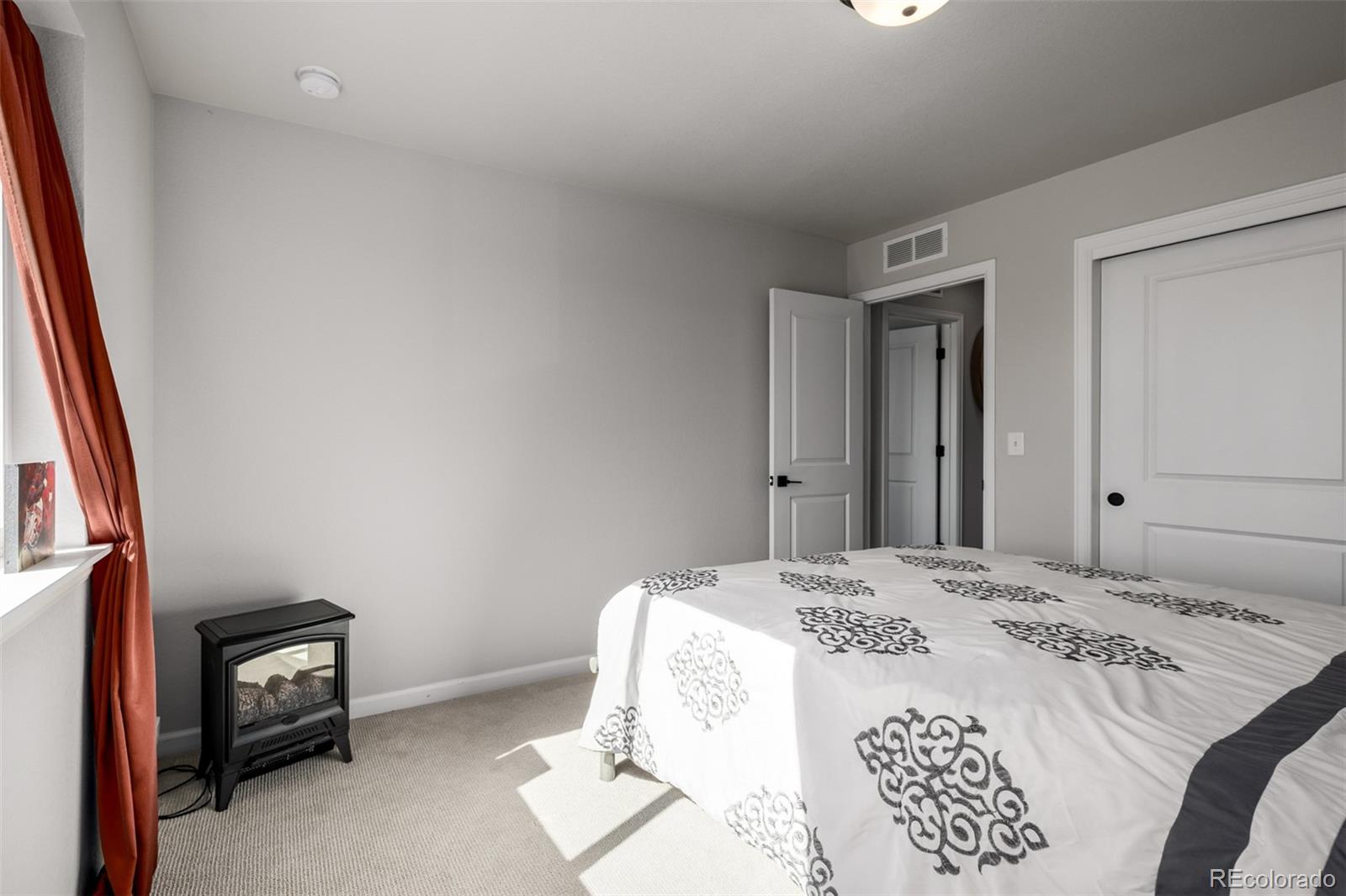 1875 Rancher Drive Milliken, CO 80543 - Photo 22 of 50 a bedroom with a bed and a tv