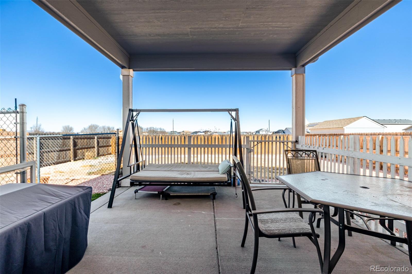 1875 Rancher Drive Milliken, CO 80543 - Photo 31 of 50 a balcony with table and chairs