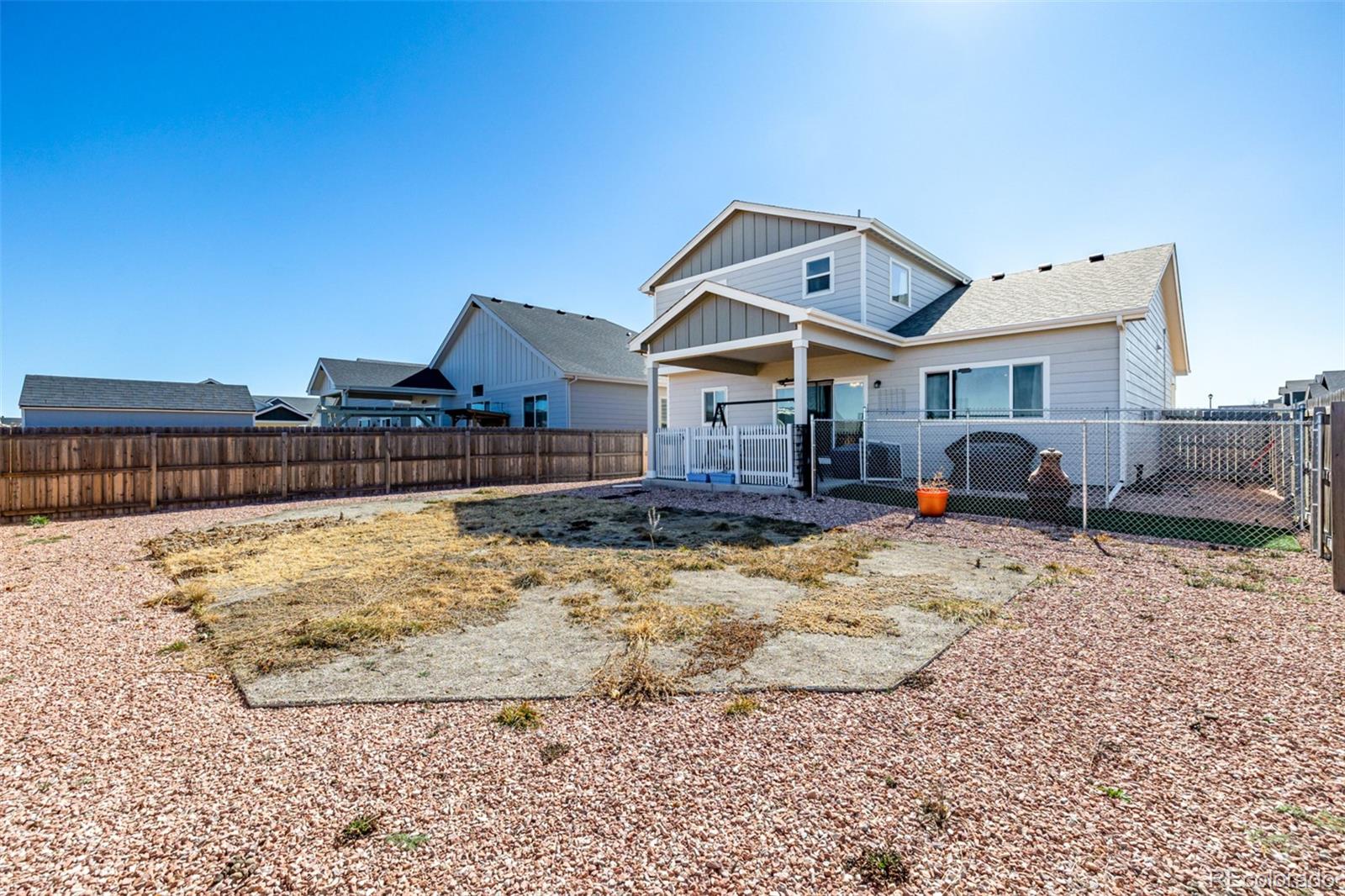 1875 Rancher Drive Milliken, CO 80543 - Photo 35 of 50 a front view of a house with a yard covered in snow