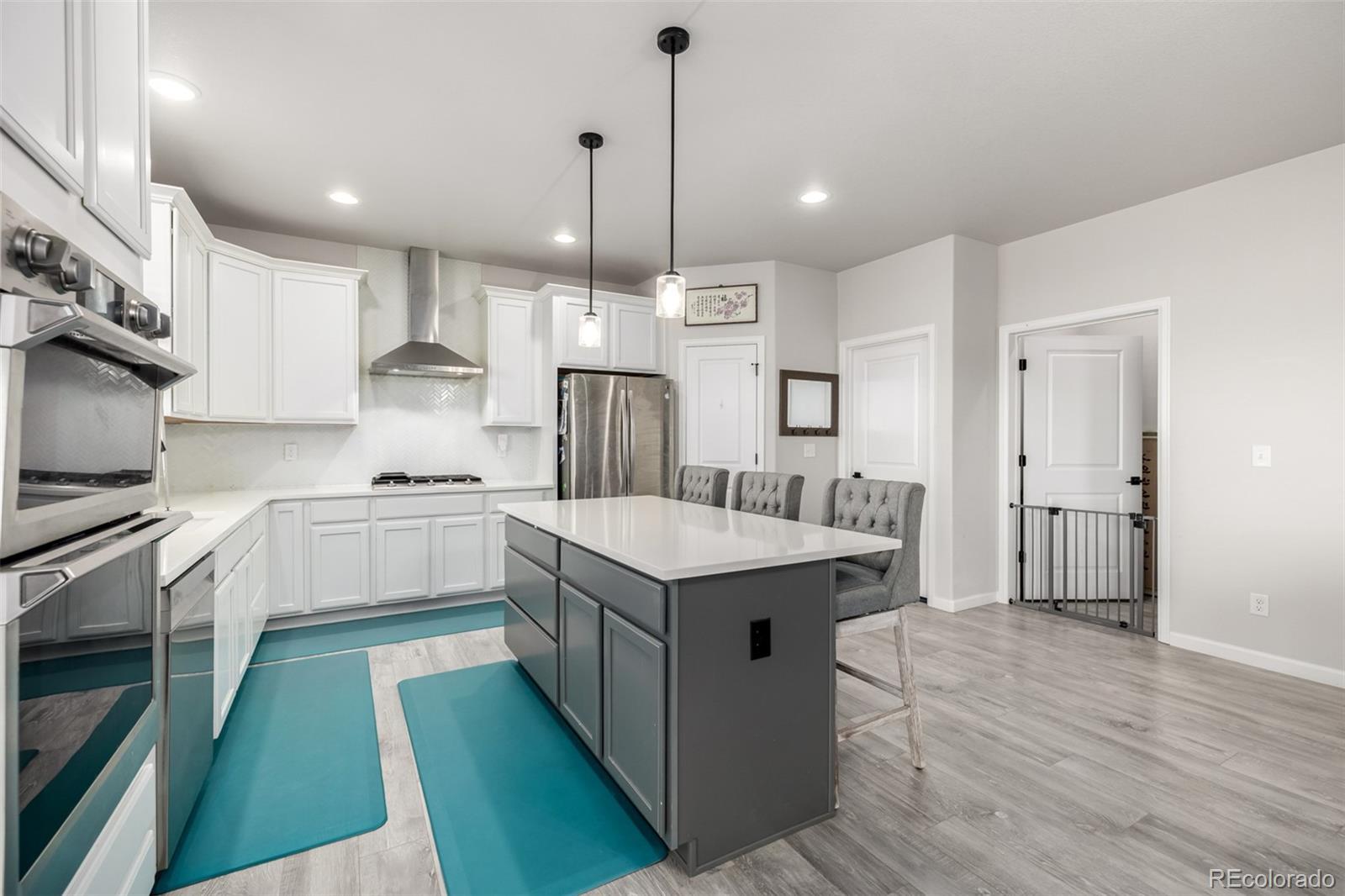 1875 Rancher Drive Milliken, CO 80543 - Photo 8 of 50 a kitchen with granite countertop a sink a counter top space stainless steel appliances and cabinets