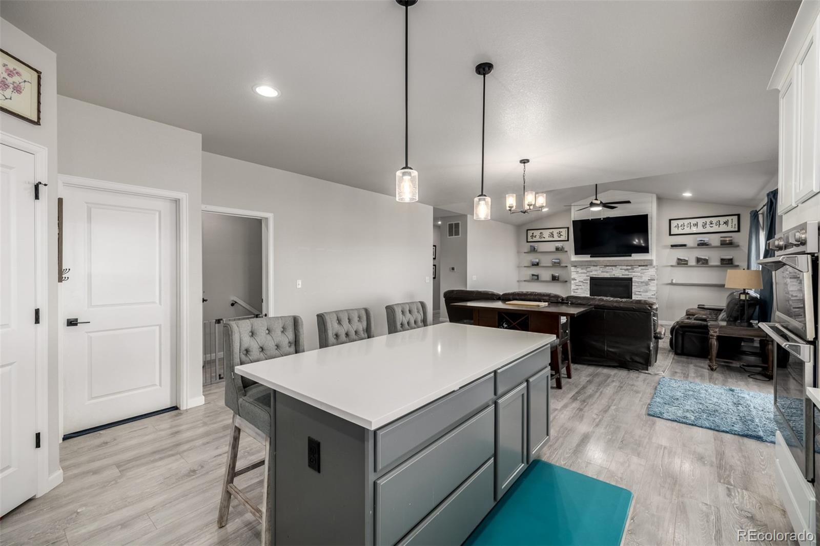 1875 Rancher Drive Milliken, CO 80543 - Photo 10 of 50 a kitchen with a sink a counter top space and stainless steel appliances
