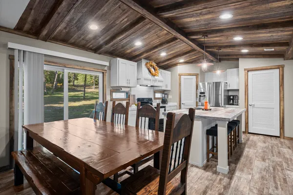 a view of a dining room with furniture window and outside view