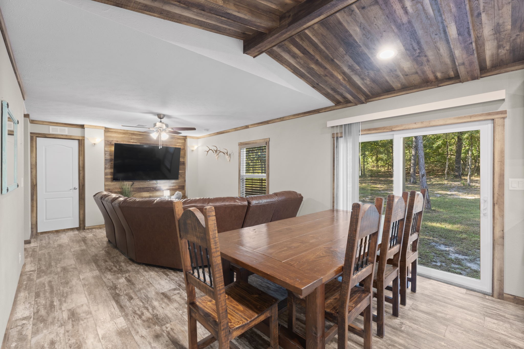 577 Winding River Road South Oakhurst, TX 77359 - Photo 12 of 31 a view of a dining room with furniture window and wooden floor