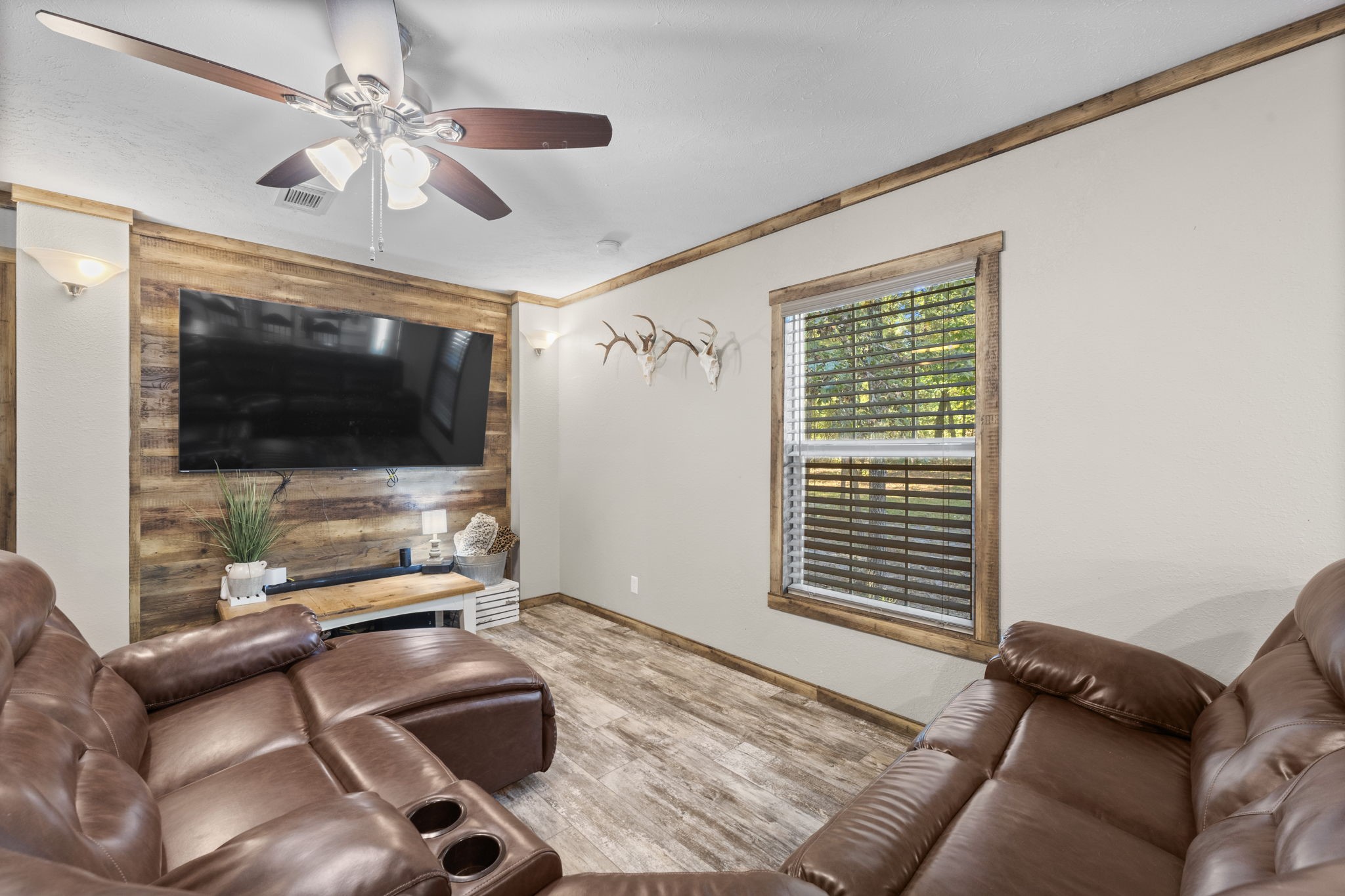 577 Winding River Road South Oakhurst, TX 77359 - Photo 14 of 31 a bedroom with furniture and flat screen tv